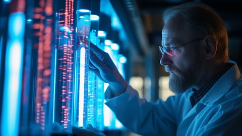 A scientist in a laboratory examining a test tube filled with a medication used to treat hypertension and cardiovascular diseases.