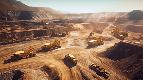 Aerial view of a large gold mine in South Africa with many excavators and trucks working.