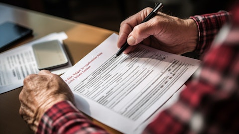 A close-up of a hand holding an individual retirement account statement.