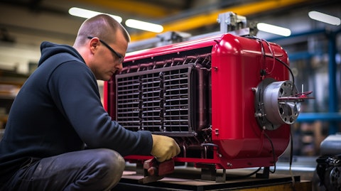 A technician in a factory, assembling a gas-fired unit heater.