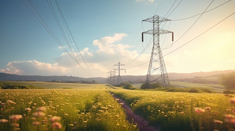 A view of a transmission tower carrying electric wires over the horizon.