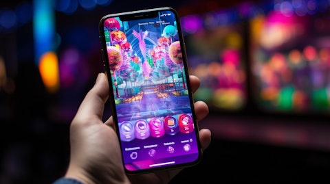 A close-up of a hand holding a mobile device with a gaming app open on the screen.