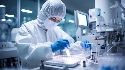 A worker at a biopharmaceutical facility packaging an active pharmaceutical ingredient.
