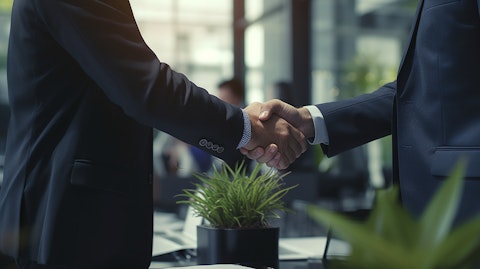 An executive shaking hands with a business client as a deal is finalized in their modern office.