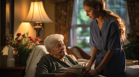 A nurse providing hospice care in a home setting, reassuring a patient’s family members.