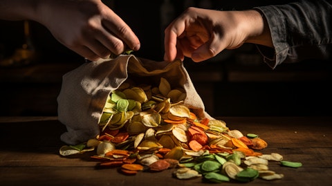 Two hands crunching into a bag of the company's organic vegetable chips.