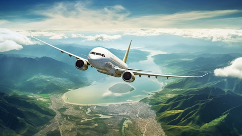 A commercial plane flying overhead with a scenic view of the region in the background.