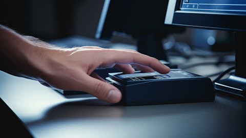 A close-up of the fingers of a technician scanning an ID, verifying the Enrollment Verification process.