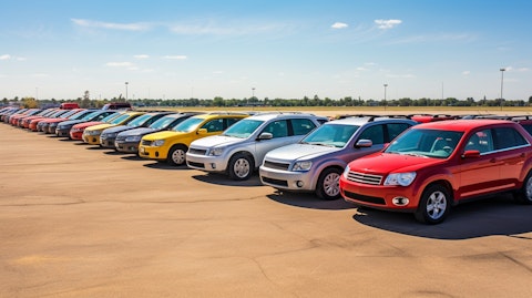 A line of used vehicles in a spacious lot, ready to be sold at an auction.
