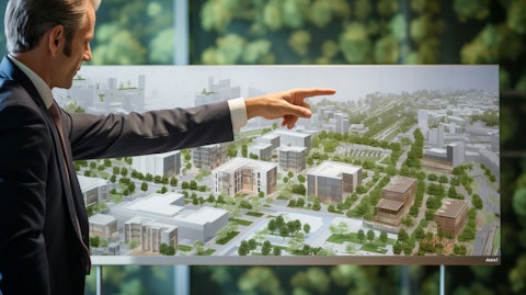 A real estate CEO pointing to a hospital facility on a financial chart.