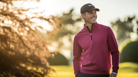 A relaxed golfer in the company's lifestyle apparel, enjoying a leisurely round.