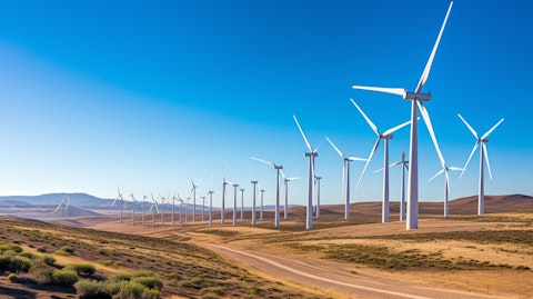 A line of wind turbines against a clear sky, reflecting the companies clean energy efforts.