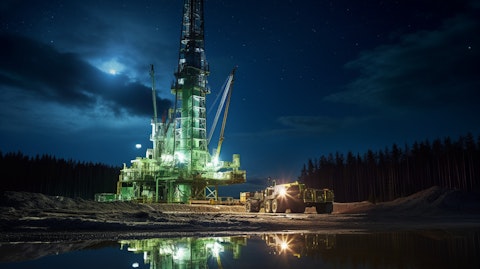 A drilling rig illuminated against the night sky, providing energy for generations.