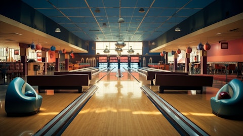 A large and spacious bowling alley, with lanes full of customers throwing strikes.