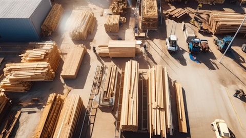 Aerial shot of a building site stocked with lumber and other building materials.