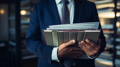 A portfolio manager holding an open binder, showing a portfolio of investments the company offers.