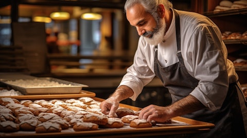 A baker in a busy bakery, arranging freshly baked treats on a tray.