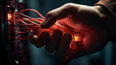 A close-up of a hand connecting wires to generate electricity.