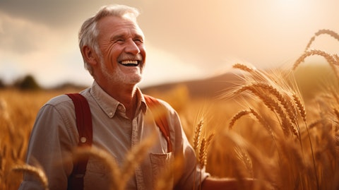 A retired farmer in a wheat field, pleased with the quality of a Food products product he purchased from the company.