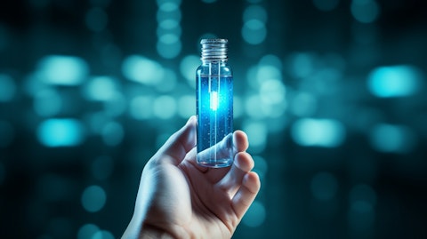 A hand holding up a glass vial containing a biopharmaceutical therapy.