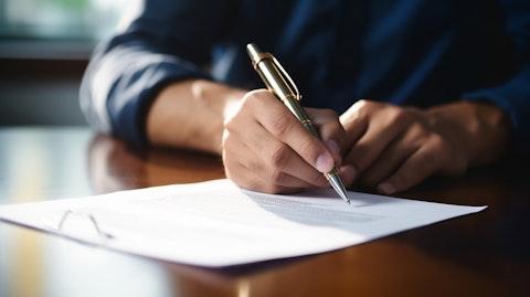 A close-up of a hand signing a contract, symbolizing the legal agreement between employer and employee.