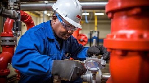 A technician working on a valve inside a natural gas facility.