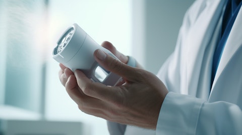A close-up of a doctor's hand pressing on an inhaler, conveying the effect of the company's therapeutic products.