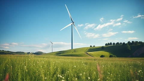 A modern wind turbine in a farm, symbolizing the company's commitment to renewable energy.