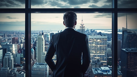A top level executive looking out of a skyscraper window, symbolizing the strategic decisions taken by the company.