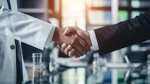 A biopharmaceutical executive shaking hands with a business partner, representing the Strategic Collaboration Agreement.