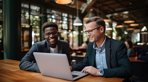 A student interacting with their professor in an online learning environment.