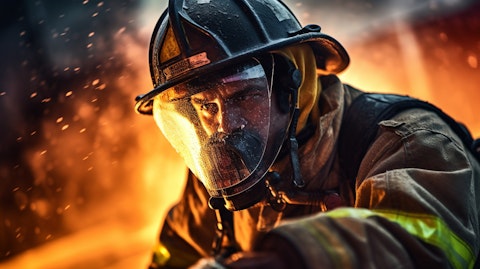A close-up view of a firefighter handling a large hose, symbolizing the strength and fortitude of these individuals.