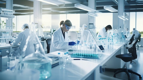 A biopharmaceutical laboratory with scientists in lab coats working on medicines.