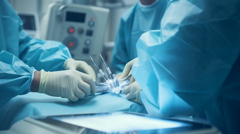 A surgeon in an operating room with an orthopeadic medical device ready for use in bunion treatment.