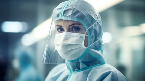 A medical professional in a hospital wearing protective apparel supplied by the healthcare solutions company.