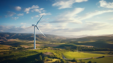 A large wind turbine generator towering over a rural landscape.