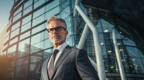 A senior financial executive in a power suit in front of a modern high rise building.