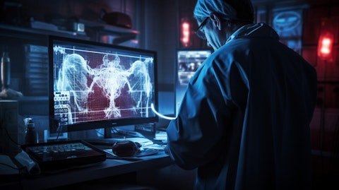 A healthcare professional in front of a console, monitoring the progress of a transplant patient.