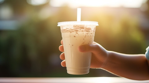 A close up of a hand of a a child holding a freshly opened packet of the company's popular ready-to-drink shake.
