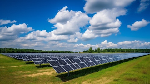 A solar farm in rural landscape with blue sky and white clouds.