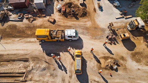 An aerial view of a construction site, the lift Boom of the specialization equipment rental services truck in the center.