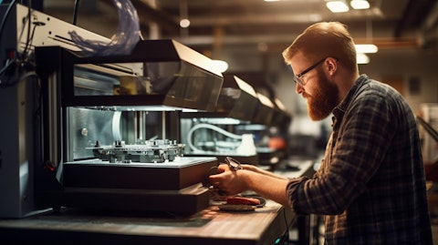 A technician using a 3D printer to produce a metal component for a customer.