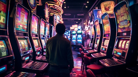 A closeup shot of slot machines and a player nervously waiting for the spin to stop.