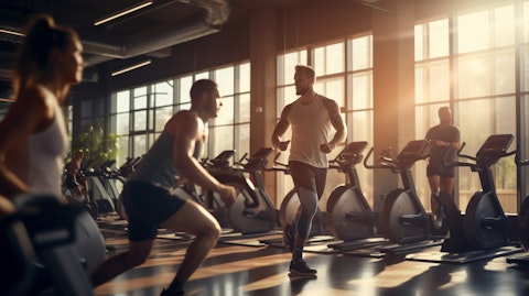 A diverse group of people engaging in various activities in a modern fitness center.