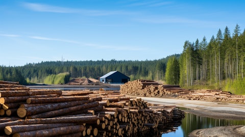 A lumber mill with pristine forests in the background, showing the company's commitment to renewable energy.