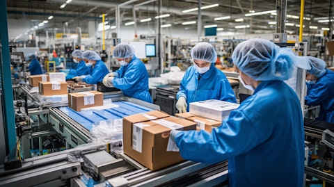 A factory line of workers working together to assemble protective packaging solutions.