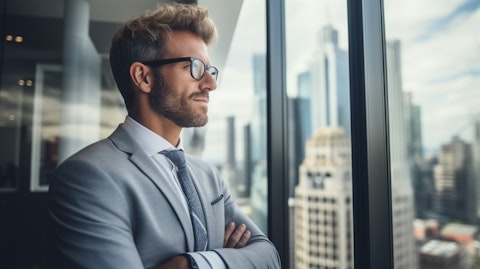 A financial advisor in a modern office looking out a window, illustrating stability and trustworthiness.