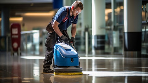 A technician calibrating and performing maintenance of a floor cleaning machine.
