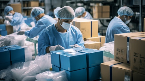 An assembly line of medical devices being packed for distribution.
