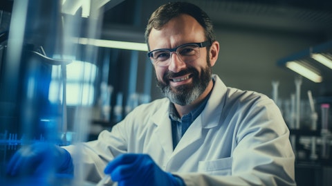 A scientist in a laboratory smiling with a test tube in hand, representing the company's research in biotechnology.